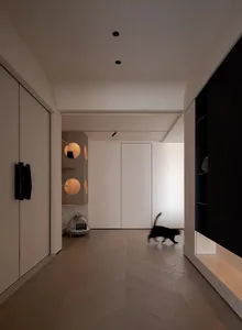 A modern residential corridor featuring a wood floor.