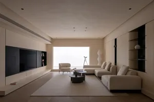 Modern minimalist studio with neutral tones and large window.