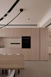 A minimalist kitchen with tiled flooring and wooden countertops.