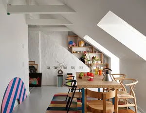 A colorful dining room with a wooden table and various decorative items on the shelves.