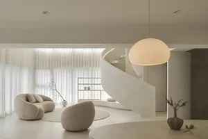 Modern living room with minimalist design and concrete floor.