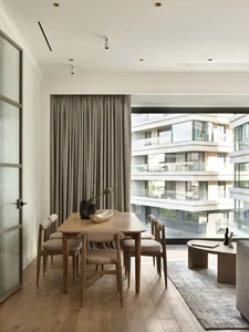 Modern interior design featuring a wooden dining table and chairs.