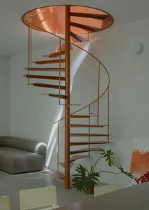 Modern interior design featuring a metal spiral staircase with a glass rail