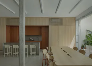 Modern kitchen with wooden cabinets and a long wooden dining table.