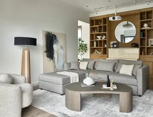 A modern living room featuring mixed materials and plush seating.