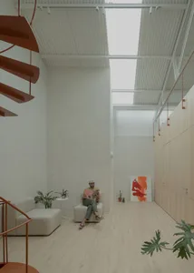 A modern lounge area featuring neutral-colored decor and furniture, with a plant and artwork on display.