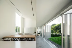 Glass and metal minimalistic residential interior with open layout and natural light.