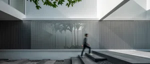 A minimalist interior design featuring a metallic fence and steps.