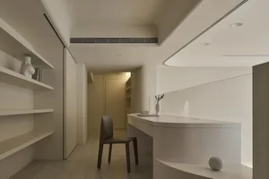 A modern office space with white surfaces, minimal decor, and a sleek, contemporary design.