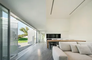 A modern residential interior featuring concrete materials and a minimalist design.