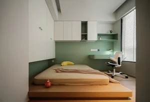 Minimalist bedroom with wooden floor, bed on a raised platform, and built-in storage