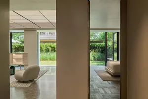 Interior design featuring a minimalist living room with neutral-toned materials