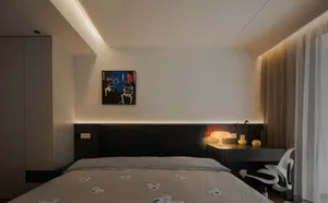 Contemporary bedroom with a black bed frame and white textiles, featuring a modern abstract painting and warm ambient lightin
