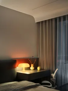 Modern bedroom featuring fabric curtains with a soft, warm light ambiance.