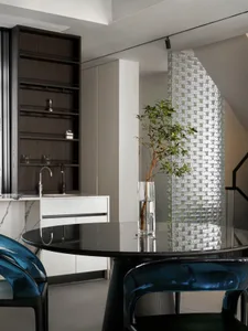 A photograph of a modern kitchen featuring transparent glass elements.
