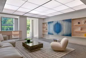 A modern living room with concrete flooring and modular furniture.