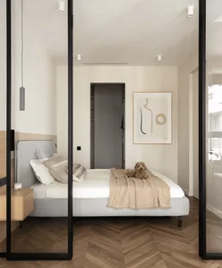 Modern minimalist bedroom with wood floor and light bedding.