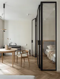 Modern living room with wooden furniture and glass doors.