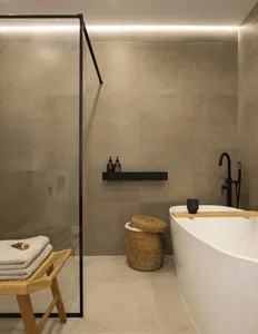 Modern minimalist bathroom with marble and stone tiles.