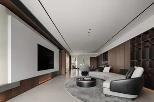 A modern living room with concrete flooring, minimalist design, and a large sectional sofa.
