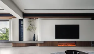 A minimalist modern living room with a sleek TV unit displaying a cozy electric fireplace.