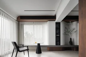 Modern minimalist living room featuring glass furniture and white blinds.