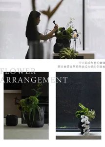 A woman arranging a black flower arrangement in a modern, minimalist space.