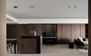 Modern living room featuring a black piano and sofa, styled with minimalist décor and hardwood flooring.