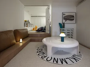 A modern living room with a round table and a sofa.
