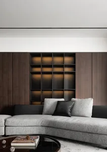 Modern living room with wooden paneled backdrop, featuring a cozy arrangement of contemporary furniture and lighting.