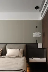 Modern minimalist bedroom featuring a bed with upholstered headboard, wooden walls, and metal nightstand.