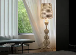 Interior with minimalist decor, metal floor lamp, and white curtains.