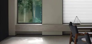 Modern minimalist office space with a window view of an indoor garden.