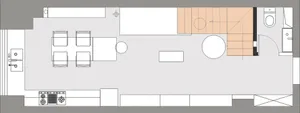 A modern open-concept living space with neutral-colored walls and a staircase in the background.