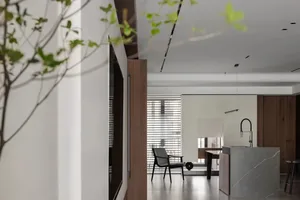 Modern residential interior with concrete, glass, and wooden elements.