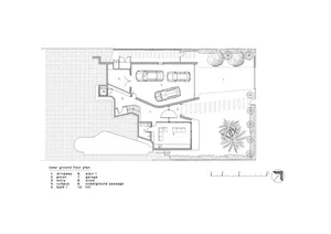 A detailed technical architectural plan of a lower-ground-level floor, depicting various rooms and spaces such as a driveway,