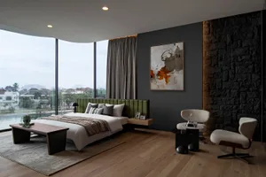 Modern minimalist bedroom with a large window overlooking a cityscape, featuring a green upholstered headboard, a wooden coff