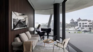 A modern living room featuring a wooden sofa, glass coffee table, and concrete floor with a grand piano and cityscape view.
