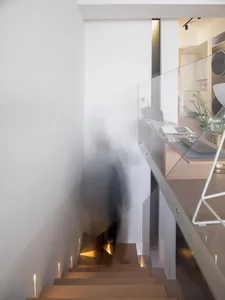A modern minimalist interior with glass and wood materials.