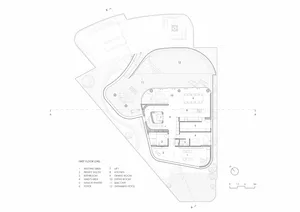 Black and white architectural drawing of a modern residential floor plan showing various rooms and spaces.