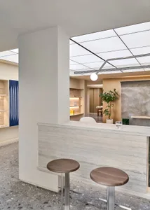 Modern industrial-style coffee shop bar counter with stools and minimalist aesthetic