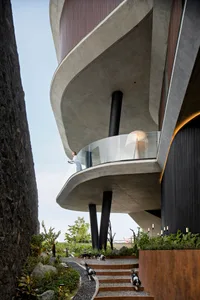 Modern residential exterior featuring concrete and glass materials.