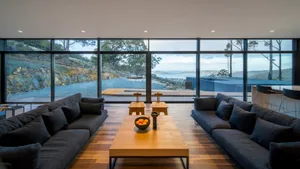 Modern living room featuring wooden furniture and a view of the outdoors.