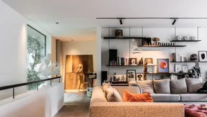 A modern living room featuring textured cork surfaces, contemporary art, and a comfortable seating arrangement with soft cush