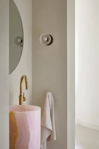 A minimalist interior design featuring a marble sink and faucet.