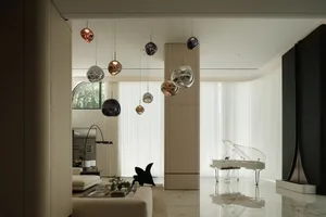 A modern living room featuring glass, steel, and marble materials