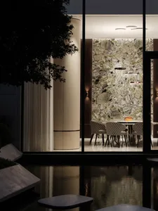 A modern restaurant interior featuring a marble wall and table