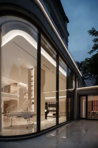 Modern residential interior featuring glass, marble, and concrete elements.