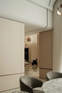 A modern, neutral-toned living room with minimalist design elements.