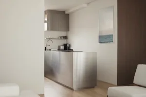 Modern, minimalist kitchen design featuring a sleek metal countertop.